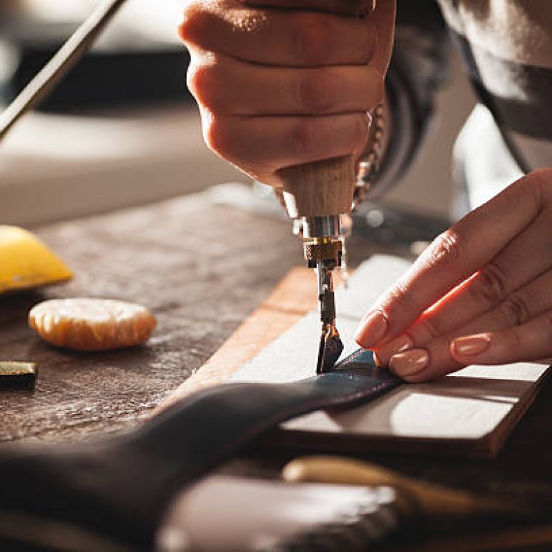 Leather handbag craftsman at work in a workshop