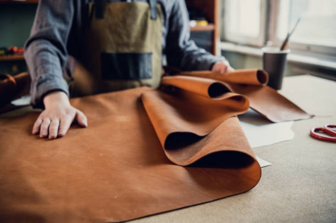 OEM luxury bag manufacturer at work in leather goods workshop